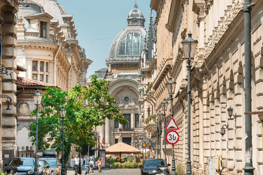 A street in Bucharest's Old Town, with the domed CEC Palace at the end of it.